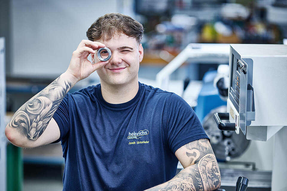 Auszubildender schaut durch ein Drehteil